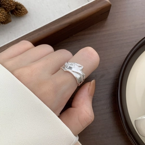 Minimalist 925 sterling silver ring with molten lava texture shown on model finger