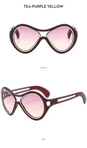 Detail view of large burgundy frame sunglasses with tea-purple-yellow gradient lenses