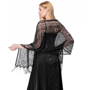 Detailed view of black lace shawl with intricate paisley patterns and long tassel fringe