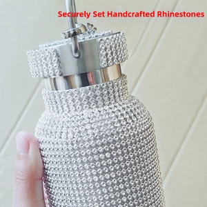 Close-up of sparkling hand-set rhinestones on a silver stainless steel thermal bottle