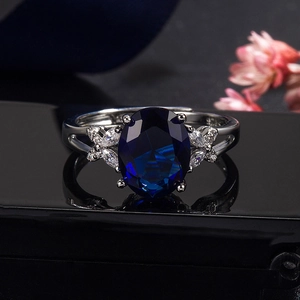 Elegant emerald cut blue sapphire ring with marquise zircon flower cluster setting