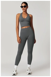 Full view of dark grey high-waist yoga set including halter sports bra and gym leggings