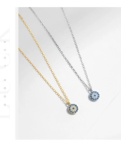 Detailed view of gold and silver S925 sterling silver evil eye necklaces with blue zircons