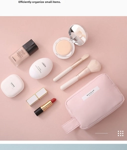 Pink waterproof makeup bag with top handle and MAKEUP BEAUTY label on pink background