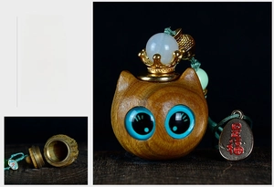 Detailed view of hollow cat wooden pendant with golden crown and storage function