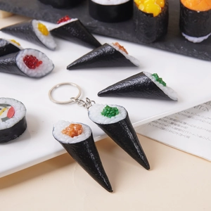 Realistic sushi keychains on a white tray featuring salmon and roe nigiri models
