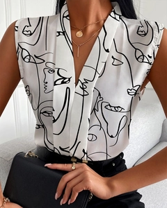 Detailed view of the V-neck silk blouse with black abstract art face line print