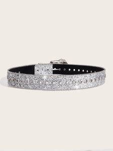 Detail of silver glitter belt with star studs and vintage floral engraved buckle