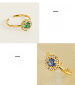 Detail view of double-layered open stainless steel rings with green and blue zircon stones