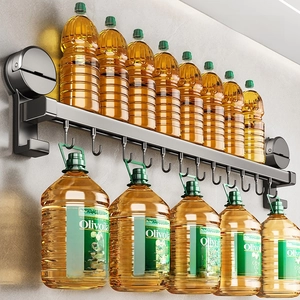 Strong suction kitchen wall rack with 10 J-hooks holding heavy oil bottles in grey metal