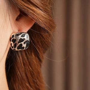 Gros plan sur les boucles d'oreilles carrées à motif léopard avec cadre en argent