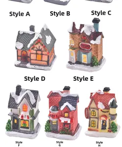 Detail view of miniature resin Christmas houses set including toy shop and cafe styles
