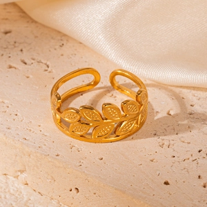Elegant 18K gold-plated stainless steel hollow leaf ring on textured stone surface