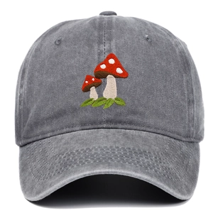 Detailed view of red mushroom embroidery on dark grey washed cotton baseball cap
