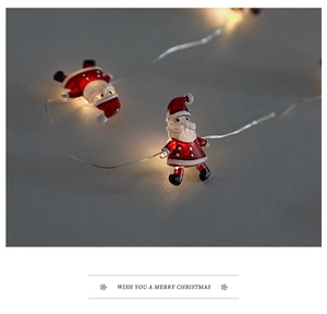 Close-up of Santa Claus LED string lights with warm yellow glow and festive greeting