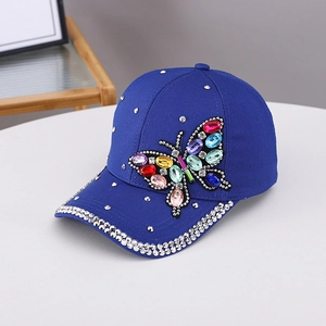 Macro detail of royal blue baseball cap with colorful rhinestone butterfly and studs