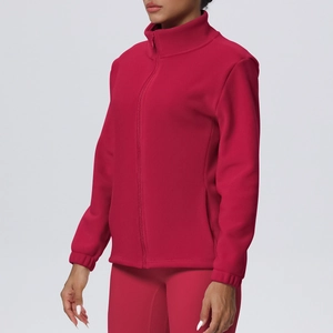 Detail of dark red fleece jacket featuring stand collar and smooth zipper closure
