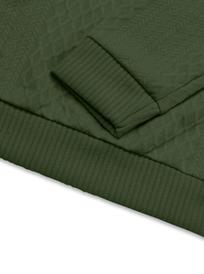 Detailed view of dark green knit shirt featuring ribbed cuffs and jacquard fabric texture