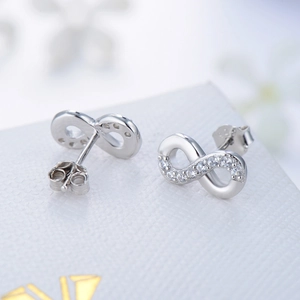 S925 sterling silver infinity earrings with white zircon stones on jewelry box