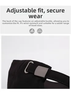 Close-up of adjustable metal buckle and stitching on black cotton baseball cap