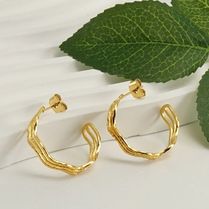 Chic gold-plated stainless steel C-shaped earrings with irregular wavy texture on a white background