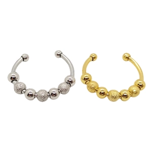 Detail of silver and gold spinning bead rings with matte and polished texture finishes