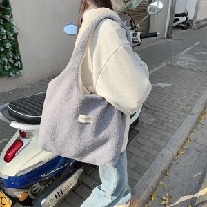 Detail of grey fuzzy plush tote bag showing the textured fabric and casual shoulder strap