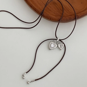 Minimalist double heart pendant necklace with brown cord and shiny zircon stones