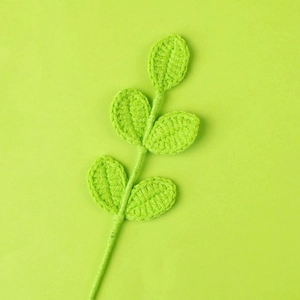 Handmade crochet yarn leaf branch in bright green with detailed knit texture