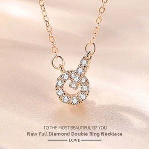 Close-up of rose gold double ring necklace pendant with sparkling white cubic zirconia