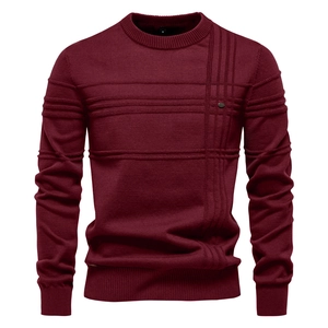 Detailed view of dark red knit sweater featuring unique textured pattern and ribbed cuffs