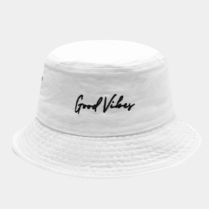 Close-up of white cotton bucket hat with black Good Vibes embroidery texture