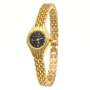 Close-up of gold chain watch with black dial and polished quartz movement detail