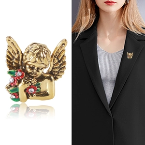 Vintage golden angel brooch with enamel flowers and rhinestones on black suit lapel