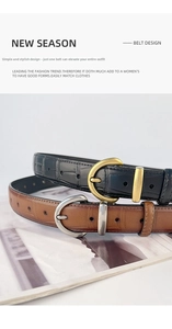 Detail of vintage crocodile embossed leather belts with gold and silver D-ring buckles