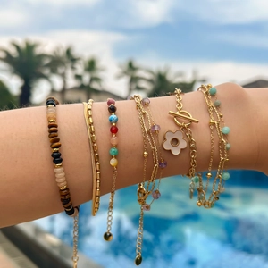 Bohemian gold chain bracelets set with colorful natural stones and a white flower charm