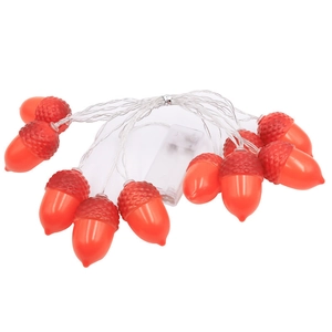 Detail view of red acorn LED string lights with battery box on white background