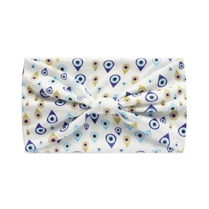 Close-up of a white bow headband featuring a colorful evil eye pattern for yoga and sports