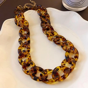 Close-up of tortoise shell resin link necklace with gold-tone metal extender chain