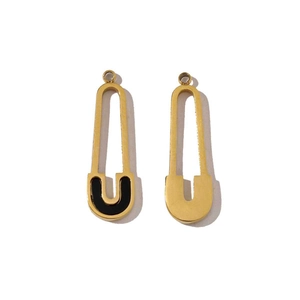 Detail of gold clip-style earrings with black enamel U-shape charms on white background