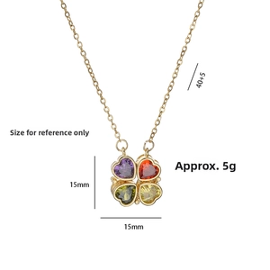 Close-up of golden four-leaf clover necklace with colorful zircon heart shaped pendants