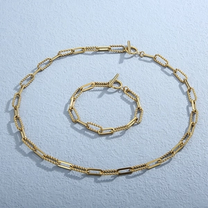 Detail of gold hip hop chunky chain necklace and bracelet set with T-bar toggle clasp