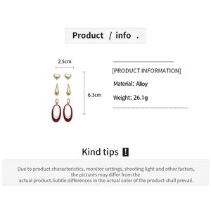 Detail view of gold alloy heart and oval drop earrings set with size and weight info
