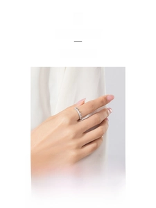 Close-up of a silver S925 crown ring featuring pavé-set zircons on a model finger