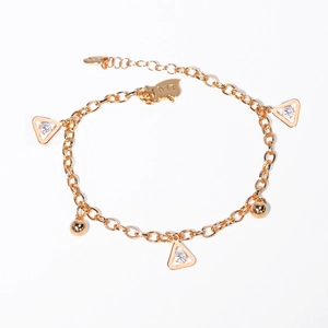 Detail of gold butterfly bracelet with triangular crystal charms and lobster clasp