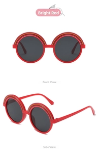 Detail view showing red round frame kids sunglasses with rainbow stripe and dark lenses
