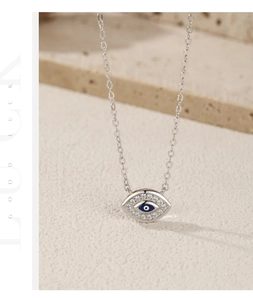 Detailed view of S925 silver evil eye pendant with blue enamel and clear crystals