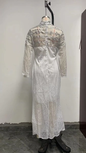Detail of silver sequin embroidery on white mesh evening dress with long sleeves