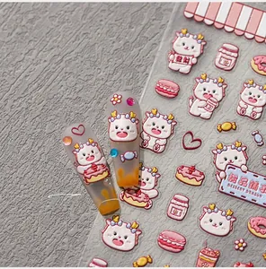 Detailed 3D relief nail art stickers featuring cute cartoon dessert dragon designs