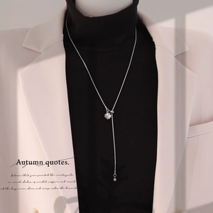 Silver heart pendant necklace on black turtleneck with adjustable sliding clasp detail